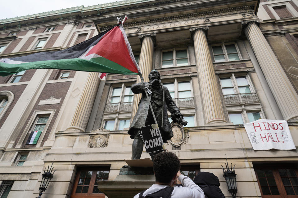 FILE - A student protester parades a Palestinian flag outside the entrance to Hamilton Hall on the campus of Columbia University, Tuesday, April 30, 2024, in New York. (AP Photo/Mary Altaffer, Pool, File)