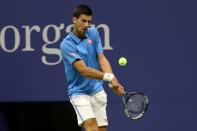 Sep 4, 2016; New York, NY, USA; Novak Djokovic of Serbia hits a backhand against Kyle Edmund of Great Britain (not pictured) on day seven of the 2016 U.S. Open tennis tournament at USTA Billie Jean King National Tennis Center. Mandatory Credit: Geoff Burke-USA TODAY Sports