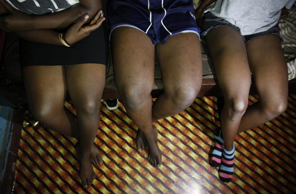 Teenage girls who became sex workers after schools in Kenya were closed in March due to coronavirus restrictions, sit in the rented room where they work in Nairobi, Kenya Thursday, Oct. 1, 2020. The girls saw their mothers' sources of income vanish when Kenya's government restricted movement to prevent the spread of the virus, and now engage in the sex work to help with household bills. (AP Photo/Brian Inganga)