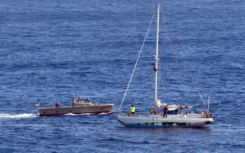 Sailors from USS Ashland approach the stranded Sea Nymph