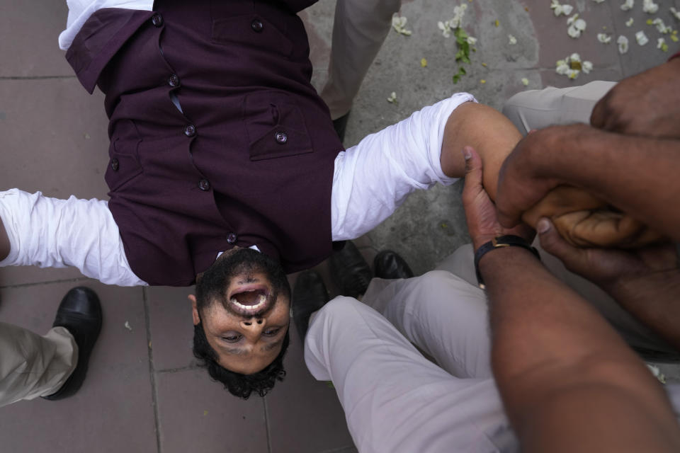 Policemen detain a member of Aam Admi Party, or Common Man's Party, during a protest against the arrest of their party leader Arvind Kejriwal in New Delhi, India, Tuesday, March 26, 2024. Indian police have detained dozens of opposition protesters and prevented them from marching to Prime Minister Narendra Modi’s residence to demand the release of their leader and top elected official of New Delhi who was arrested last week in a liquor bribery case. (AP Photo/Manish Swarup)