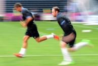 England's forward Wayne Rooney (R) runs during a training session at the Dombass Arena stadium in Donetsk on the eve of the team's Euro 2012 opening football match