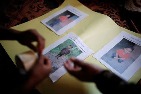 FILE PHOTO: Women make an altar with pictures of Felipe Gomez Alonzo, a 8-year-old boy detained alongside his father for illegally entering the U.S., who fell ill and died in the custody of U.S. Customs and Border Protection (CBP), at the family's home in the village of Yalambojoch, Guatemala December 27, 2018. REUTERS/Luis Echeverria