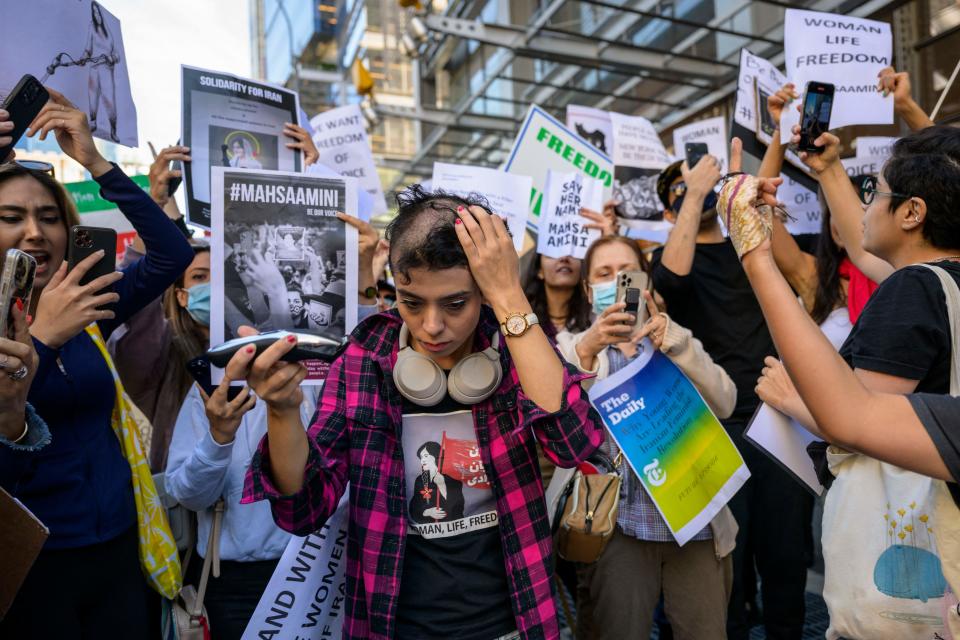  September 27, 2022: Activist Forouzan Farahani shaves her head in protest over the death of Mahsa Amini in Iran outside The New York Times building in New York City. More than 75 people have been killed in the Iranian authorities' crackdown against unrest sparked by the death of Kurdish woman Mahsa Amini in morality police custody.