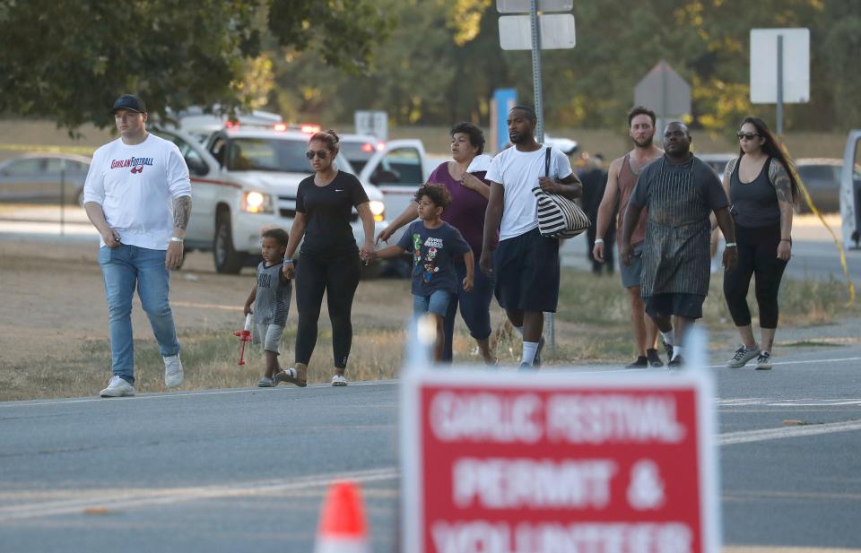 People leave the Gilroy Garlic Festival following a deadly shooting in Gilroy, Calif., on Sunday, July 28, 2019.