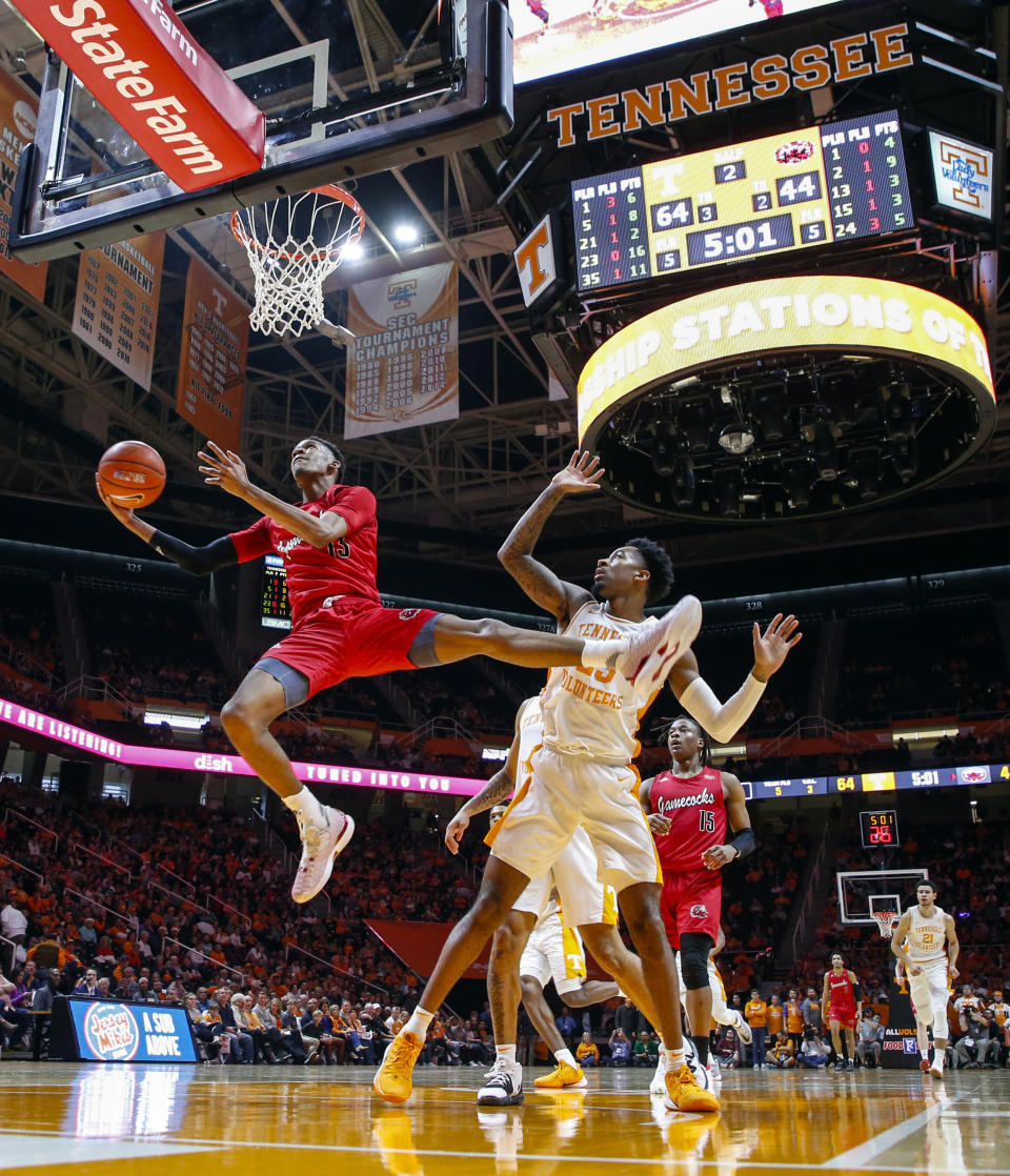 Jacksonville State guard Elias Harden (13) shoots past Tennessee guard Jordan Bowden (23) during the second half of an NCAA college basketball game Saturday, Dec. 21, 2019, in Knoxville, Tenn. Tennessee won 75-53. (AP Photo/Wade Payne)