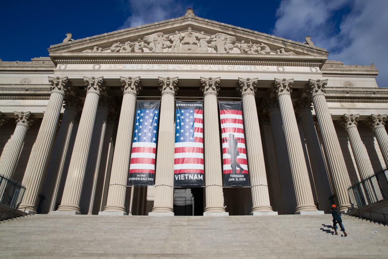 People walk up the steps even though the National Archives was closed in a partial government shutdown, Dec. 22, 2018 in Washington. While the Archives safeguards precious national documents such as the Declaration of Independence, the Constitution and the Bill of Rights, that's only the public face of their sprawling collection, which spans 13 billion pages of text and 10 million maps, charts and drawings, as well as tens of millions of photographs, films and other records.