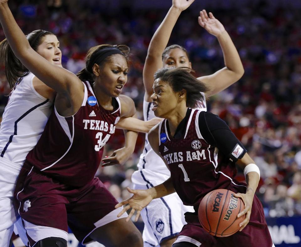 Texas A&M's Courtney Williams (1) drives to the basket past teammate Karla Gilbert (34), Connecticut's Stefanie Dolson, left, and Connecticut's Kaleena Mosqueda-Lewis, right rear, during the second half of a regional final game in the NCAA college basketball tournament in Lincoln, Neb., Monday, March 31, 2014. (AP Photo/Nati Harnik)