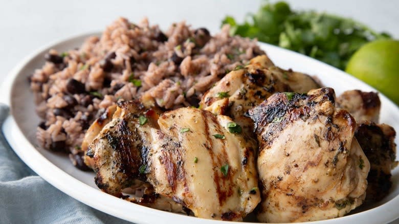 chicken with rice and beans on white serving dish