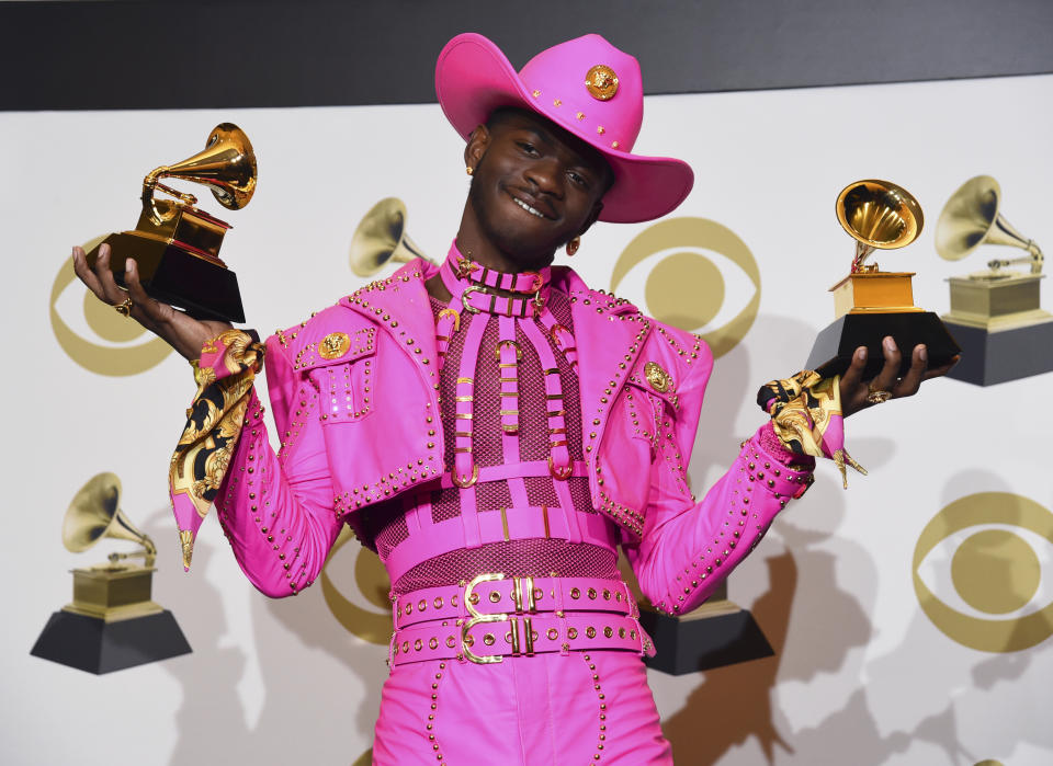 Lil Nas X poses in the press room with the awards for best music video and best pop duo/group performance for "Old Town Road," at the 62nd annual Grammy Awards at the Staples Center on Sunday, Jan. 26, 2020, in Los Angeles. (AP Photo/Chris Pizzello)