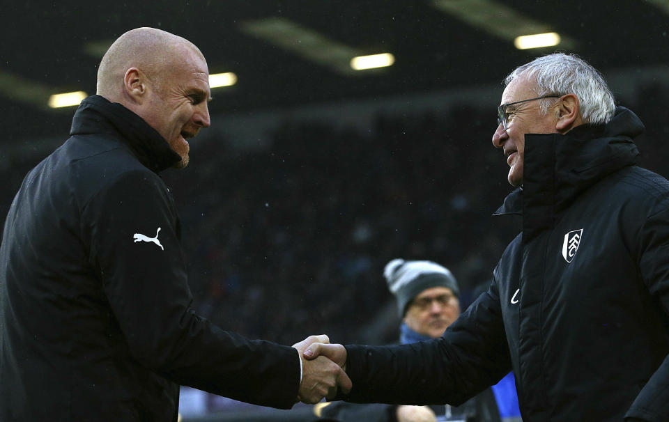 Burnley manager Sean Dyche, left, greets Fulham manager Claudio Ranieri during the English Premier League soccer match between Burnley F.C and Fulham at the Turf Moor stadium, Burnley, England. Saturday, Jan. 12, 2019. (Dave Thompson/PA via AP)