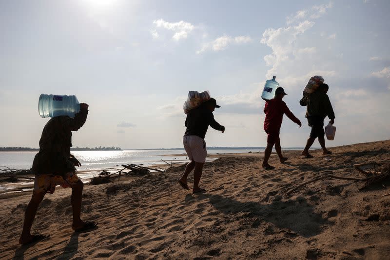 FILE PHOTO: People affeted by historic drought in the Amazon receive food and water