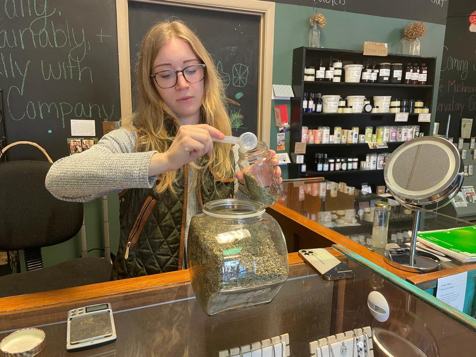 Quartz and Company owner Lexie Jones fills a jar with herbs at her downtown Howell shop, Wedneday, March 13, 2024