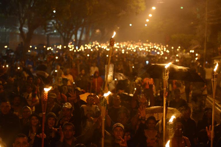 Thousands of demonstrators march toward the US Embassy demanding the resignation of Honduras' President Juan Orlando Hernandez, accused of corruption, in Tegucigalpa, June 12, 2015