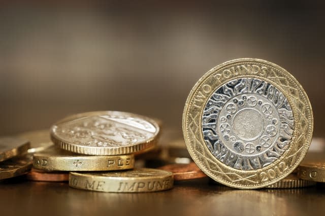 British coins over blurred background.  One and two pound coins.