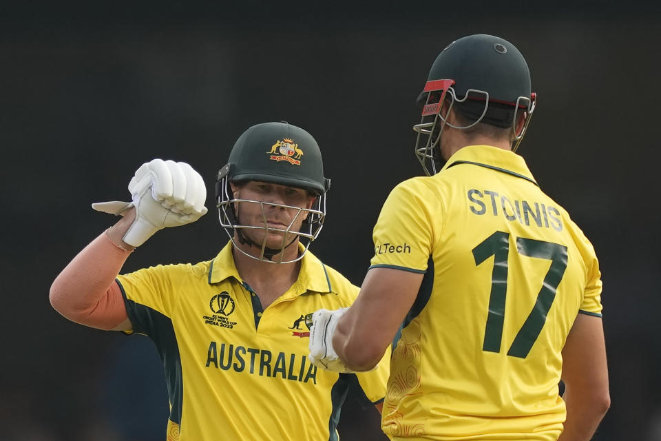 Australia's David Warner congratulates teammate Marcus Stoinis for hitting a six during the ICC Men's Cricket World Cup match between Australia and Pakistan in Bengaluru, India, Friday, Oct. 20, 2023. (AP Photo/Eranga Jayawardena)