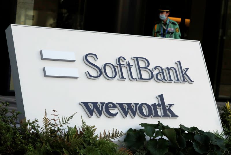 The logos of SoftBank and WeWork are displayed in front of SoftBank's new headquarters building in Tokyo
