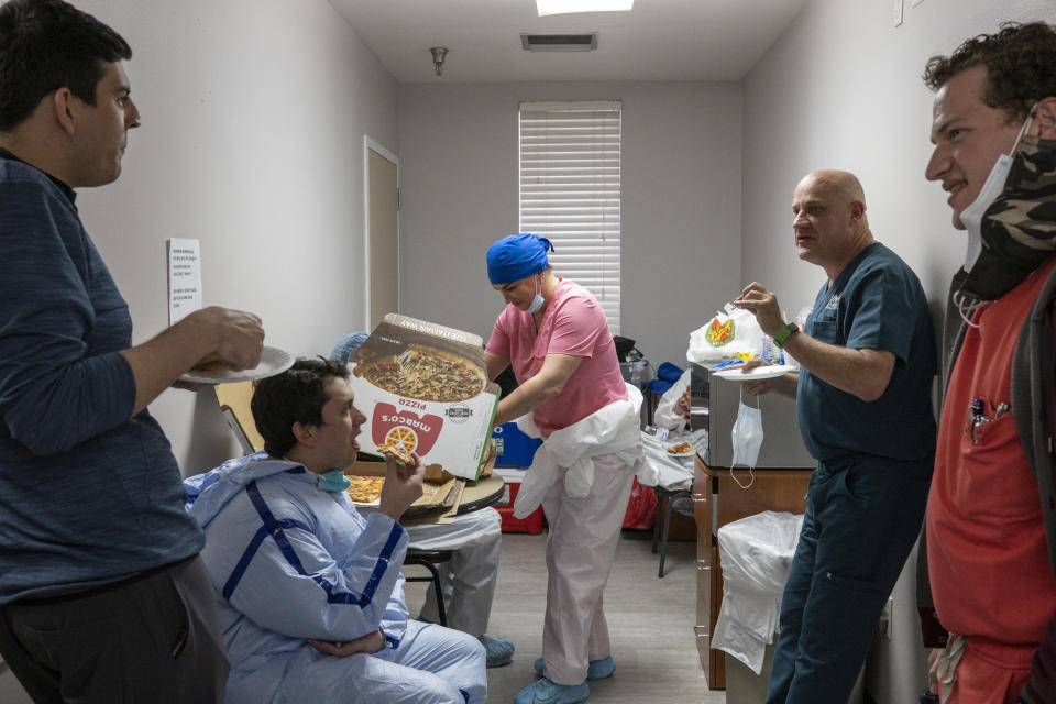 HOUSTON, TX - DECEMBER 2: (EDITORIAL USE ONLY) Medical staff members take a break as they eat pizzas in a lounge in the COVID-19 intensive care unit (ICU) at the United Memorial Medical Center on December 2, 2020 in Houston, Texas. According to reports, Texas has reached over 1,280,000 cases, including over 22,200 deaths. (Photo by Go Nakamura/Getty Images)