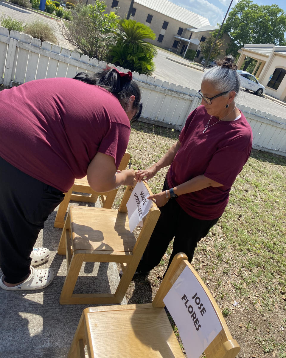 Lydia and Monica Morales create a memorial for the Texas school shooting victims using little chairs from their daycare; Monica remembers many of the victims as toddlers and preschoolers. (Danielle Campoamor)