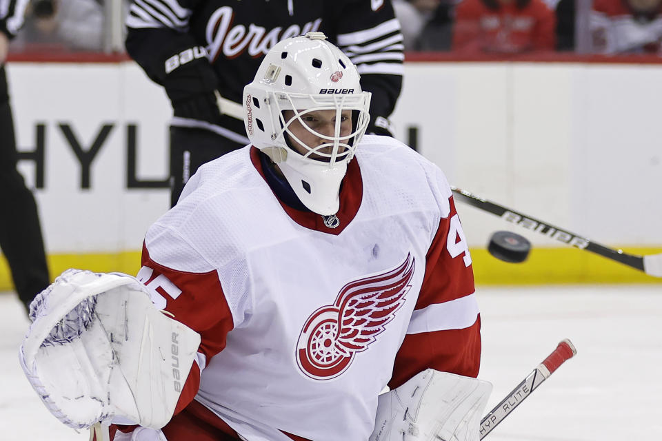 Detroit Red Wings goaltender Michael Hutchinson watches a New Jersey Devils shot go wide during the second period of an NHL hockey game Saturday, Dec. 23, 2023, in Newark, N.J. (AP Photo/Adam Hunger)