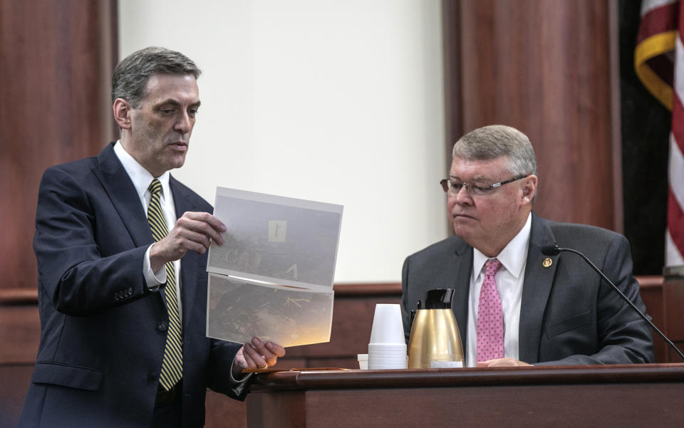 Solicitor Rick Hubbard shows former SLED investigator David Lawrence photographs in evidence from the scene where the Jones children were located, during the sentencing phase of the trial of Timothy Jones Jr. in Lexington, S.C., Thursday, June 6, 2019. Timothy Jones, Jr. has been found guilty of killing his 5 young children in 2014. (Tracy Glantz/The State via AP, Pool)