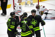 Dallas Stars left wing Jason Robertson (21) is congratulated by teammates Miro Heiskanen (4) and Radek Faksa (12) after scoring a goal during the third period of an NHL hockey game against the Chicago Blackhawks, Sunday, Feb. 7, 2021, in Dallas. (AP Photo/Sam Hodde)