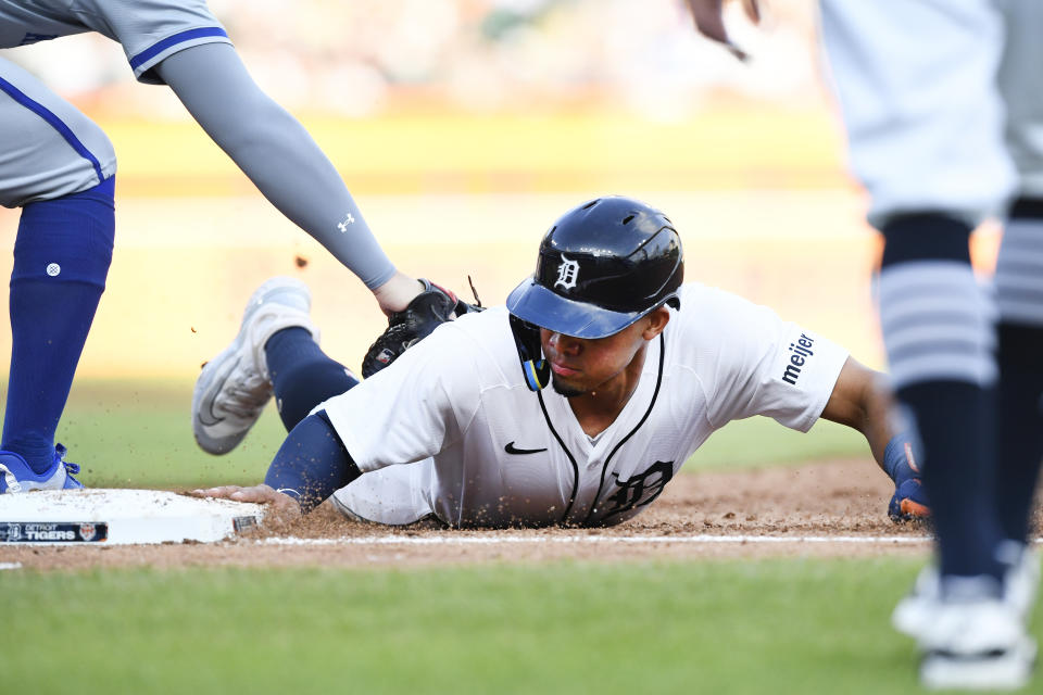 Detroit Tigers' Wenceel Pérez slides safely back to first base before the tag of Kansas City Royals first baseman Vinnie Pasquantino during the third inning of a baseball game Saturday, April 27, 2024, in Detroit. (AP Photo/Jose Juarez)