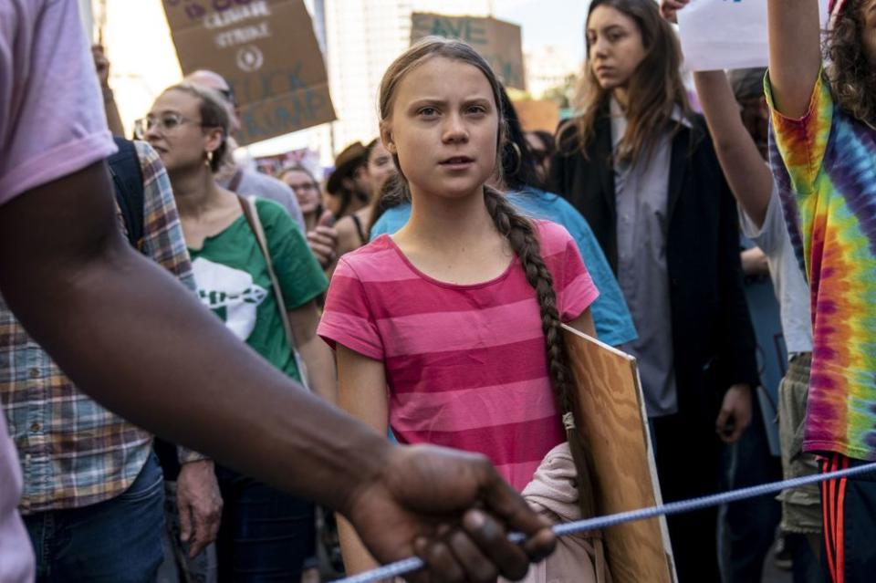 Greta Thunberg (center) | Drew Angerer/Getty