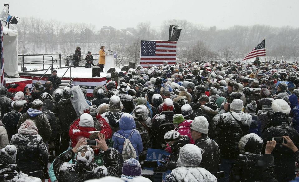 Democratic Sen. Amy Klobuchar, left, addresses a snowy rally where she announced she is entering the race for president Sunday, Feb. 10, 2019, at Boom Island Park in Minneapolis. (AP Photo/Jim Mone)