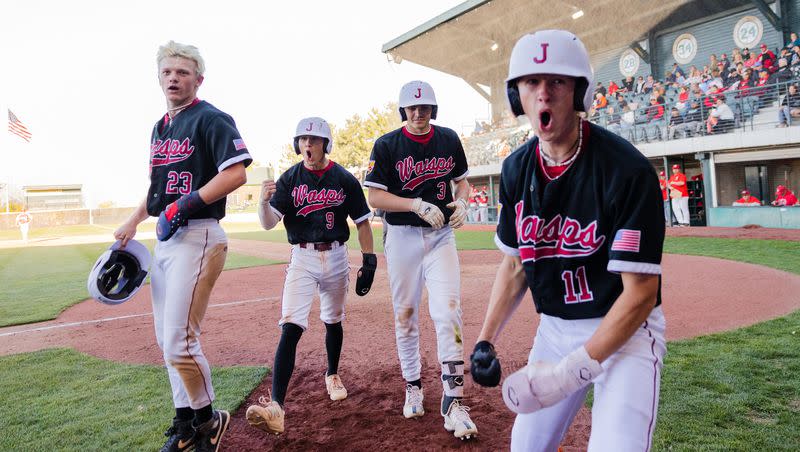 Juab’s Connor Cowan (23), Cooper Ford (9), Cael Smith (3), and Austin Park (11) celebrate after scoring a run during the 3A boys baseball state quarterfinals at Kearns High School in Kearns on Thursday, May 11, 2023.