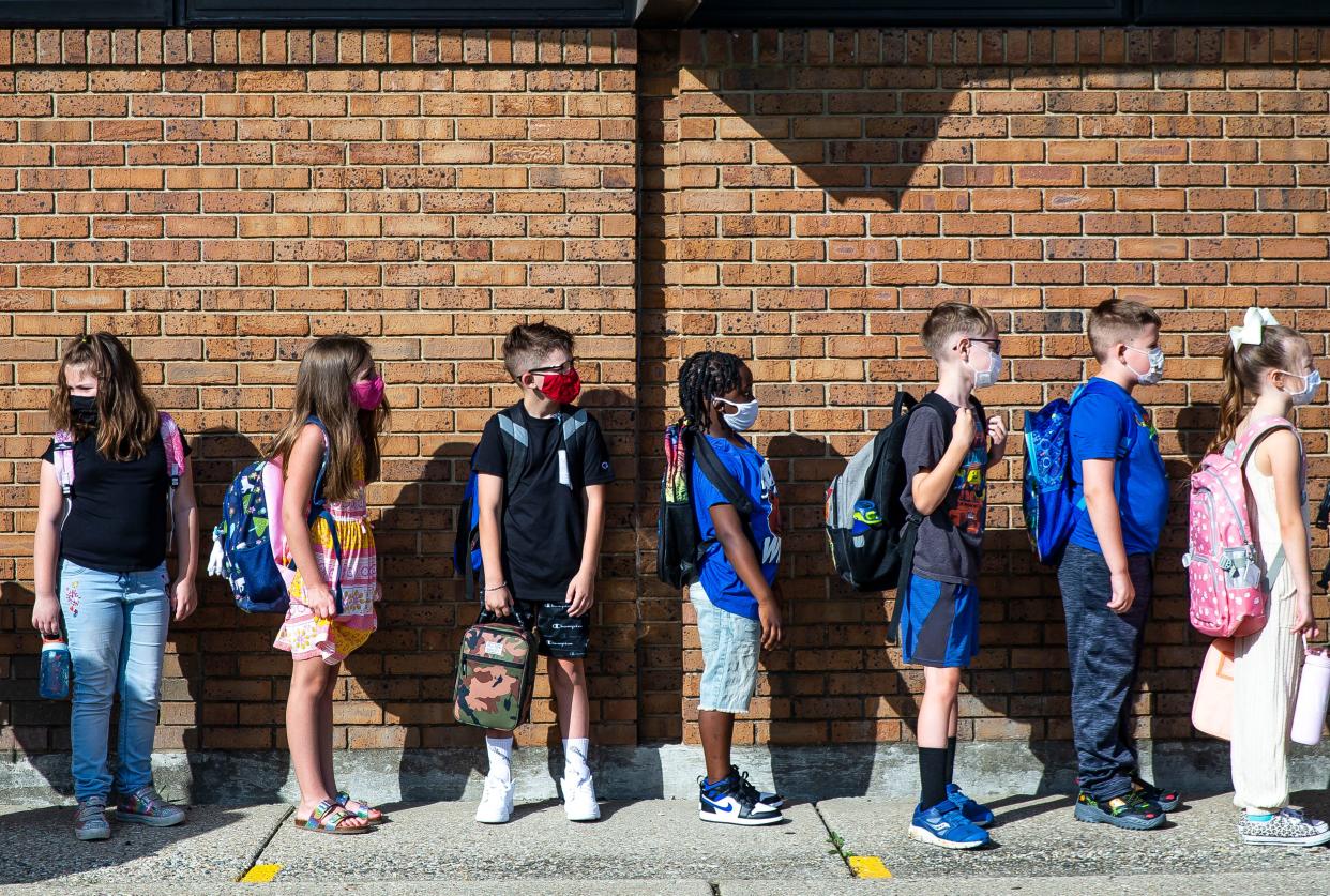 Students line up for third grade teacher Amanda Buxton on the first day of school for District 186 at Owen Marsh Elementary School in Springfield on Aug. 23, 2021. Illinois public and private schools are required to have indoor masking for staff and children in pre-kindergarten through 12th grade and in child-care centers [Justin L. Fowler/The State Journal-Register]