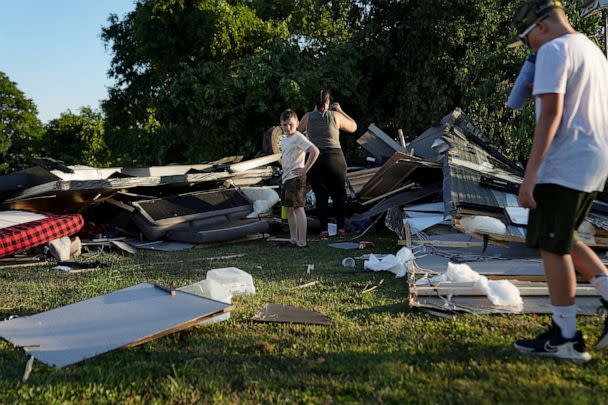 PHOTO: People survey what's left of an RV camper after a tornado touched down in several areas of Greenwood, Ind., June 25, 2023. (Jenna Watson/USA Today Network)