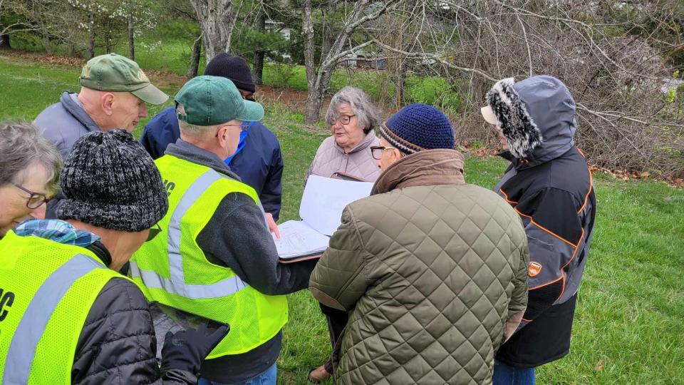 Hendersonville Tree Board member Glenn Lange, center, talks with residents who live next to the property at the Blue Ridge Mall, where developers are hoping to build an extended-stay hotel.