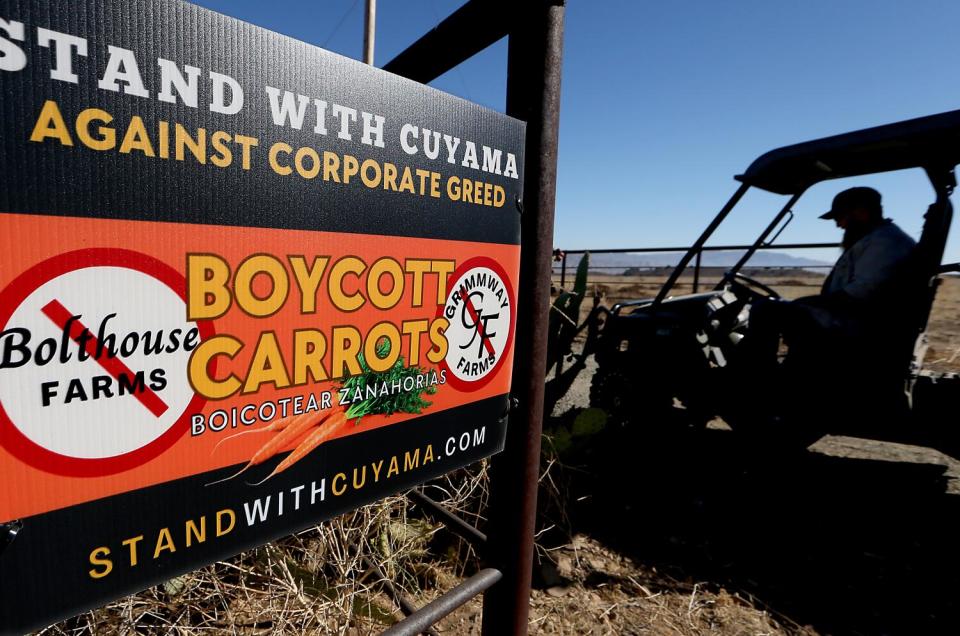 A sign promoting the carrot boycott hangs on a fence at Charlie Bosma's ranch in the Cuyama Valley.