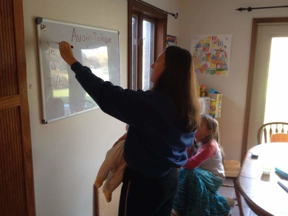 Indiana mom Heidi Orth breastfeeds while teaching. "I am a homeschool mom of nine, and every day, various duties call," she told HuffPost. <br /><br />"I have nursed while teaching, doing laundry, even cooking (safely of course!)," she added. "My husband took this photo of me conjugating French verbs on a whiteboard while nursing our eigth&nbsp;child."