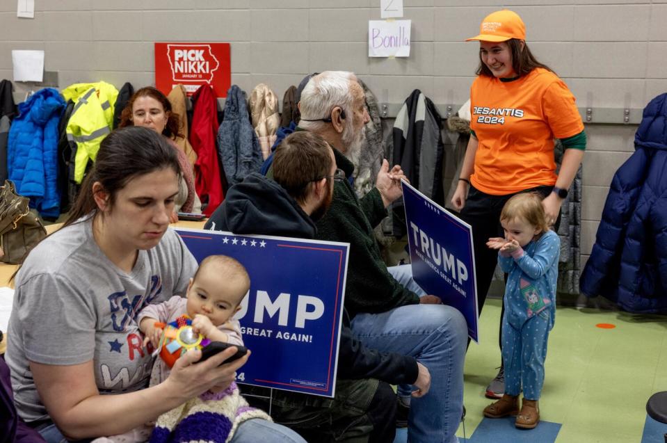 Deborah Stoner, formerly of Huntington Beach, now living in Ames, Iowa, right, speaks with a Trump supporter.