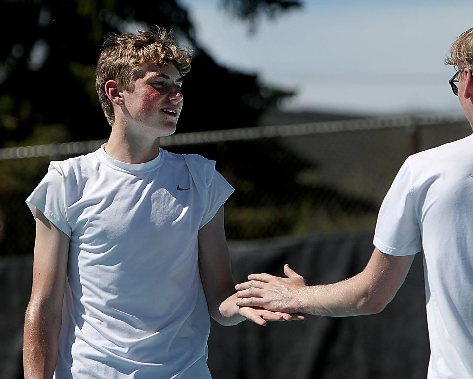 Milbank's Joe Schulte (left) and teammate Benett Street congratulate each other during a first flight doubles match Monday in the state Class A high school boys tennis tournament at Rapid City.