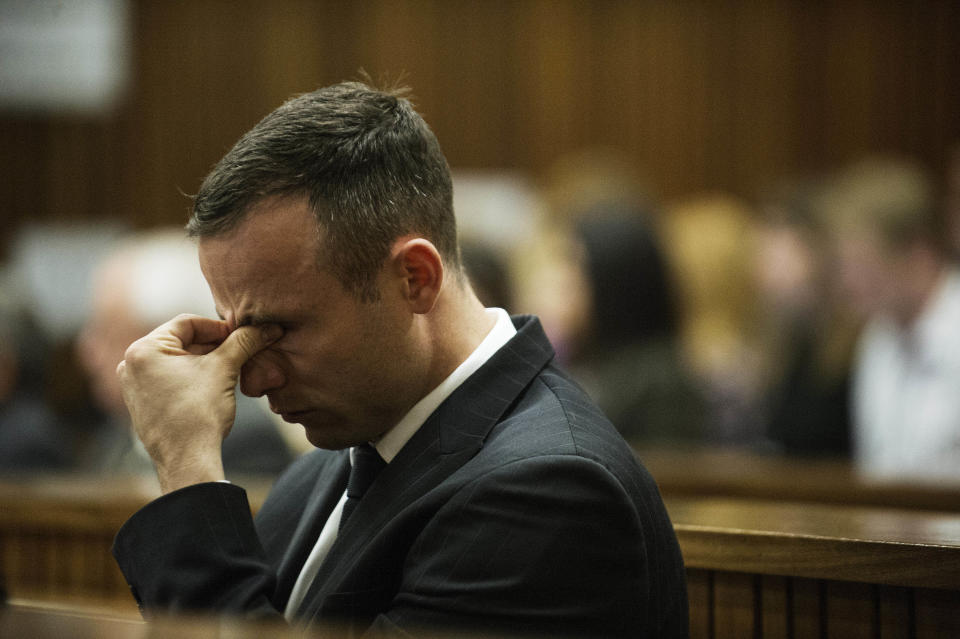 Oscar Pistorius reacts as he listens to forensic evidence being given in court in Pretoria, South Africa, Wednesday, April 16, 2014. Pistorius is charged with the murder of his girlfriend, Reeva Steenkamp, on Valentines Day in 2013. (AP Photo/Gianluigi Guercia, Pool)