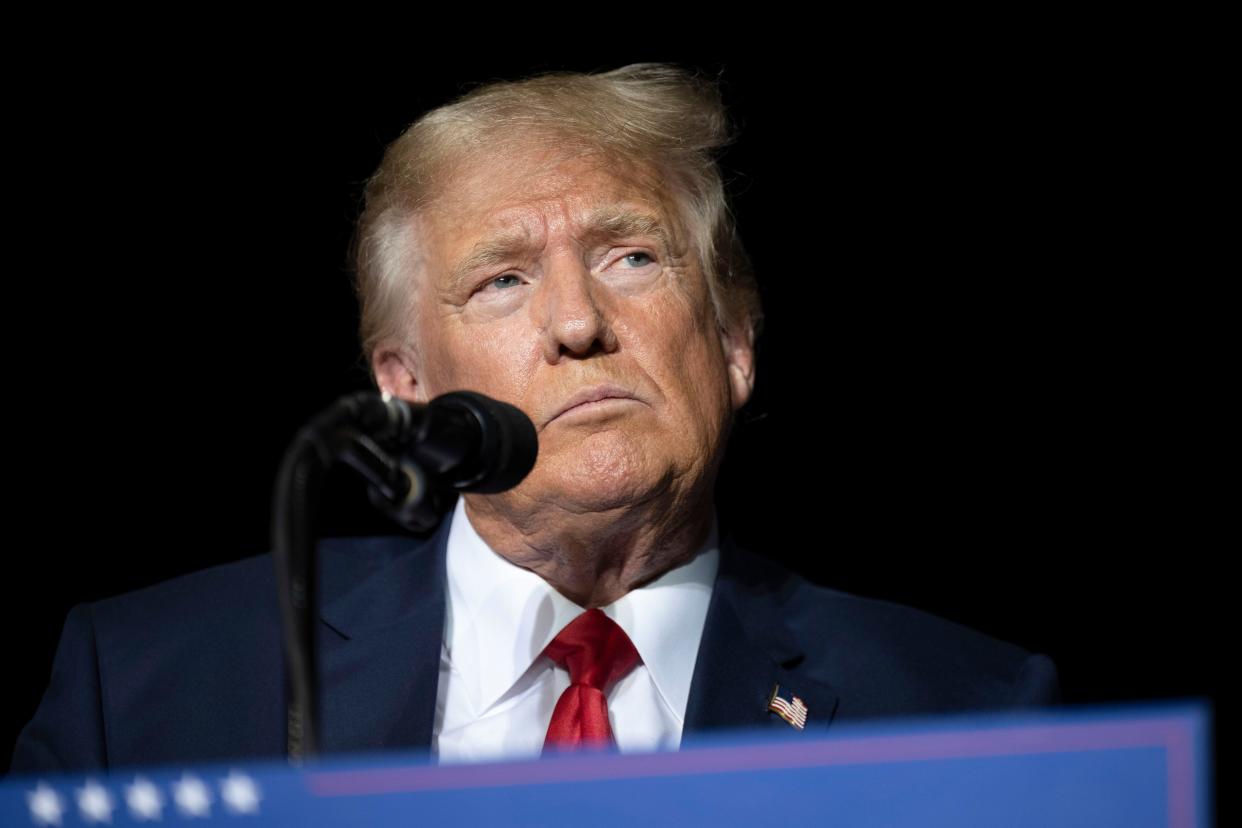 Former President Donald Trump pauses while speaking at a rally at the Minden Tahoe Airport in Minden, Nev., on Oct. 8, 2022. 