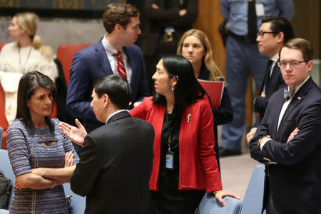 U.S. Ambassador to the United Nations Nikki Haley (L) speaks with Chinese Deputy Ambassador to the United Nations Wu Haitao (R) ahead of the United Nations Security Council session on imposing new sanctions on North Korea, in New York, U.S., December 22, 2017. REUTERS/Amr Alfiky