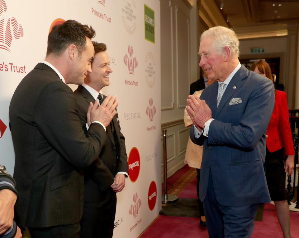 File photo dated 11/03/20 of the Prince of Wales using a Namaste gesture to greet television presenters Ant McPartlin (left)and Declan Donnelly as he arrives at the annual Prince's Trust Awards 2020 held at the London Palladium. The Prince of Wales has tested positive for coronavirus and is displaying mild symptoms "but otherwise remains in good health", Clarence House has said.