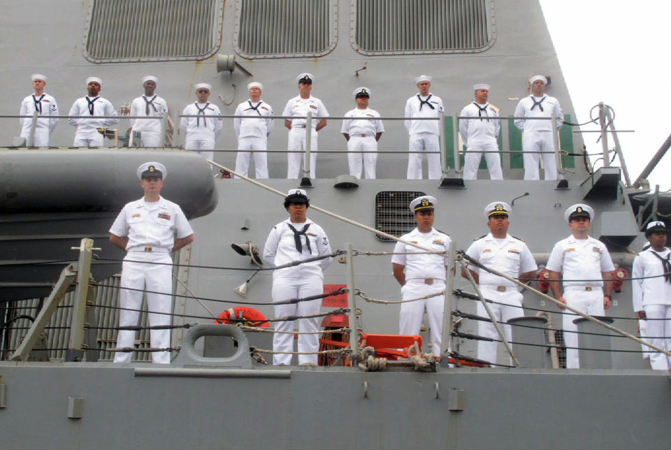 FILE - In this Aug. 8, 2016, file photo, U.S. Navy sailors stand on deck of the guided missile destroyer USS Benfold as it arrives in port in Qingdao in eastern China's Shandong Province, U.S.-China friction has flared again, with Beijing firing back at accusations by Washington that it is a leading cause of global environmental damage and has reneged on its promise not to militarize the South China Sea. (AP Photo/Borg Wong, File)