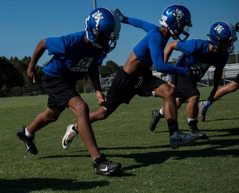 Players run through drills during football practice at Marbury High School in Marbury, Ala., on Thursday, Aug. 15, 2019.