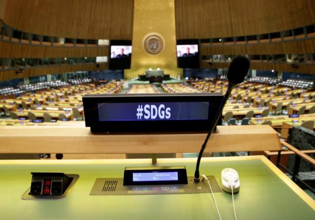 A view of empty desks at the UN General Assembly Hall with a screen that reads &quot;#SDGs&quot;