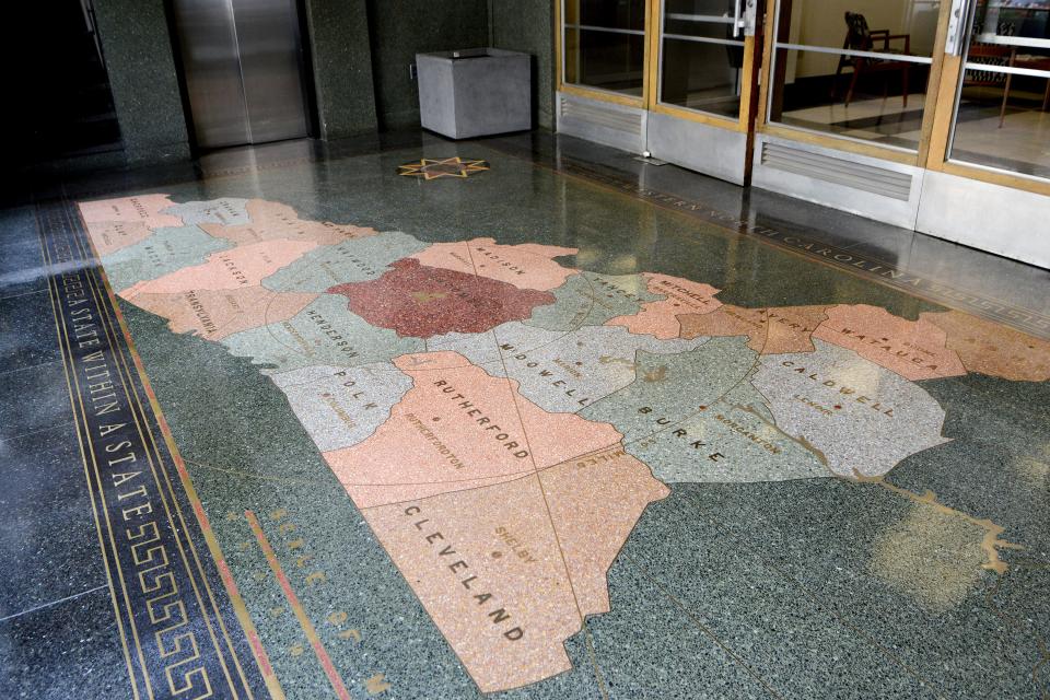 A mural showing a map of Western North Carolina, "a state within a state," adorns the floor of the Asheville Citizen Times building at 14 O. Henry Ave. downtown.