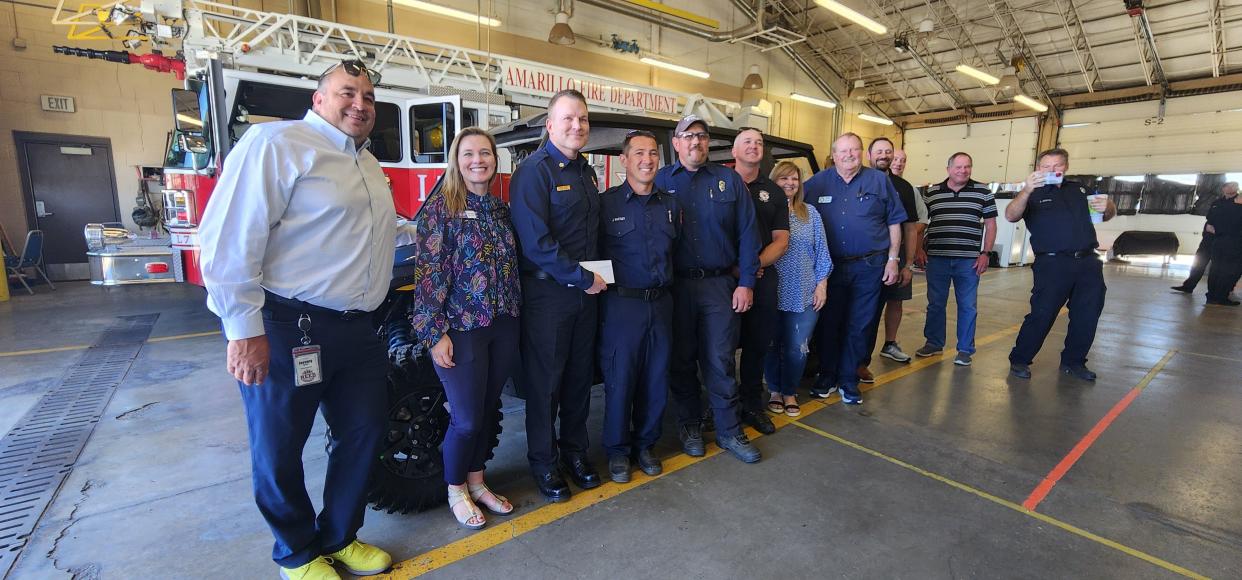 Members of the Amarillo Fire Department, Amarillo National Bank and the 100 Club of the Texas Panhandle at a donation of a new utility vehicle Tuesday at Fire Station 7 in east Amarillo.