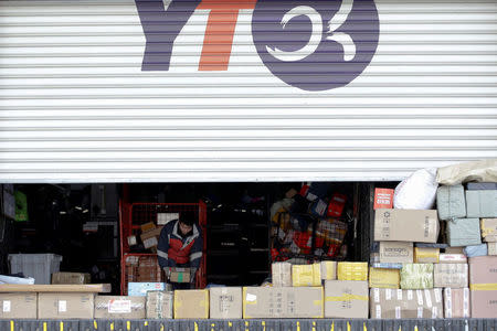 A worker sorts parcels at a YTO Express logistics centre in Beijing, China, March 25, 2016. REUTERS/Jason Lee/File photo