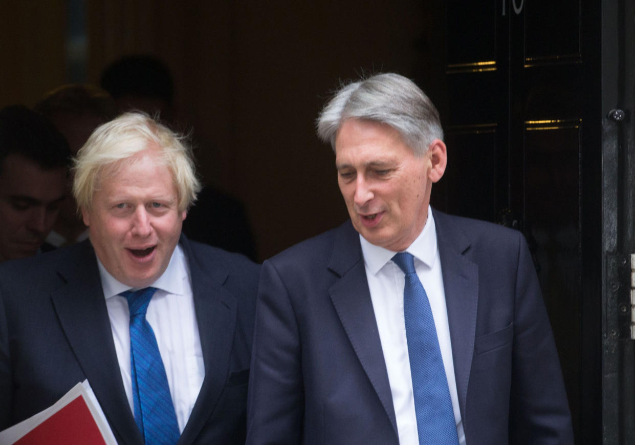 Boris and Hammond picture leaving Number 10 last week (Rex)