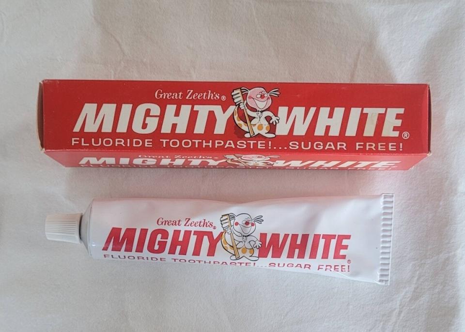 Mighty White fluoride toothpaste tube and box with the tagline "Great Teeth's Mighty White Fluoride Toothpaste!... Sugar Free!"