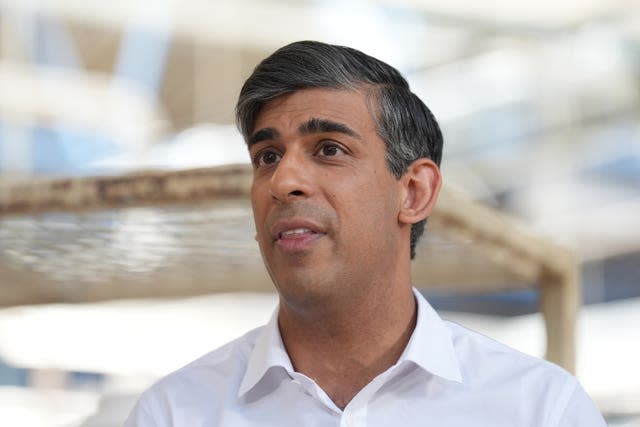 Prime Minister Rishi Sunak in a white shirt with no tie